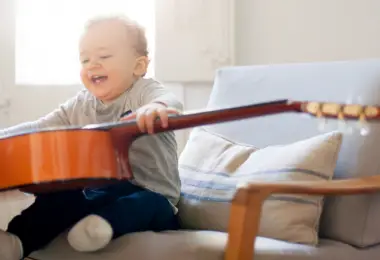 Toddler playing the guitar